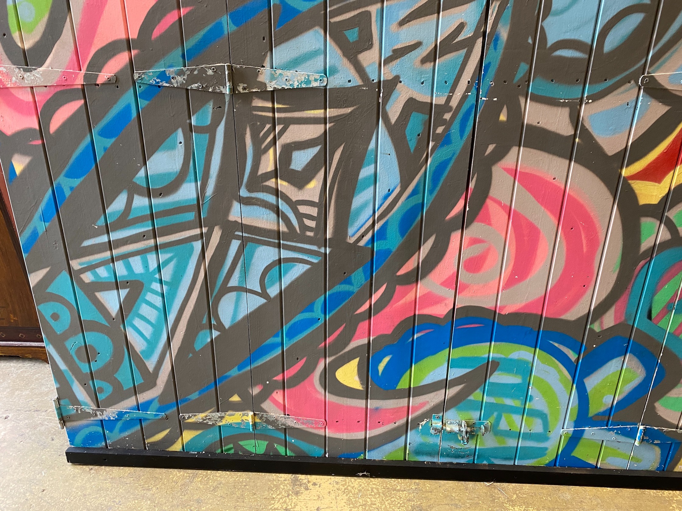 A wooden door from Camden Market with painted graffiti art width 216cm, height 207cm